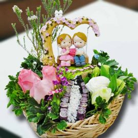 Couple On A Tree Swing Resin Figurine & 3 Peach Roses in Basket.